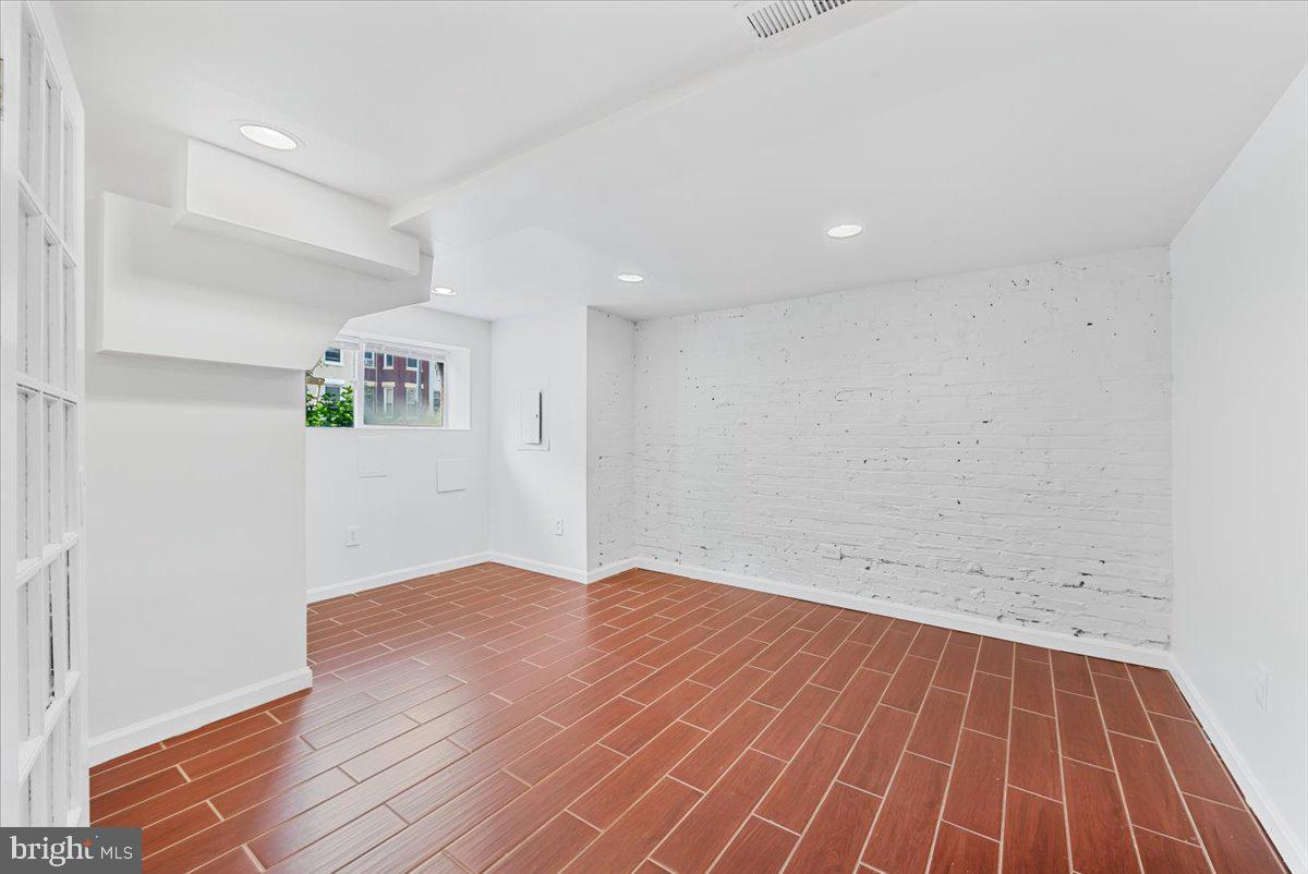 30 R Street Northeast, Unit B Washington, DC 20002 - Photo 5 of 21 an empty room with wooden floor and windows