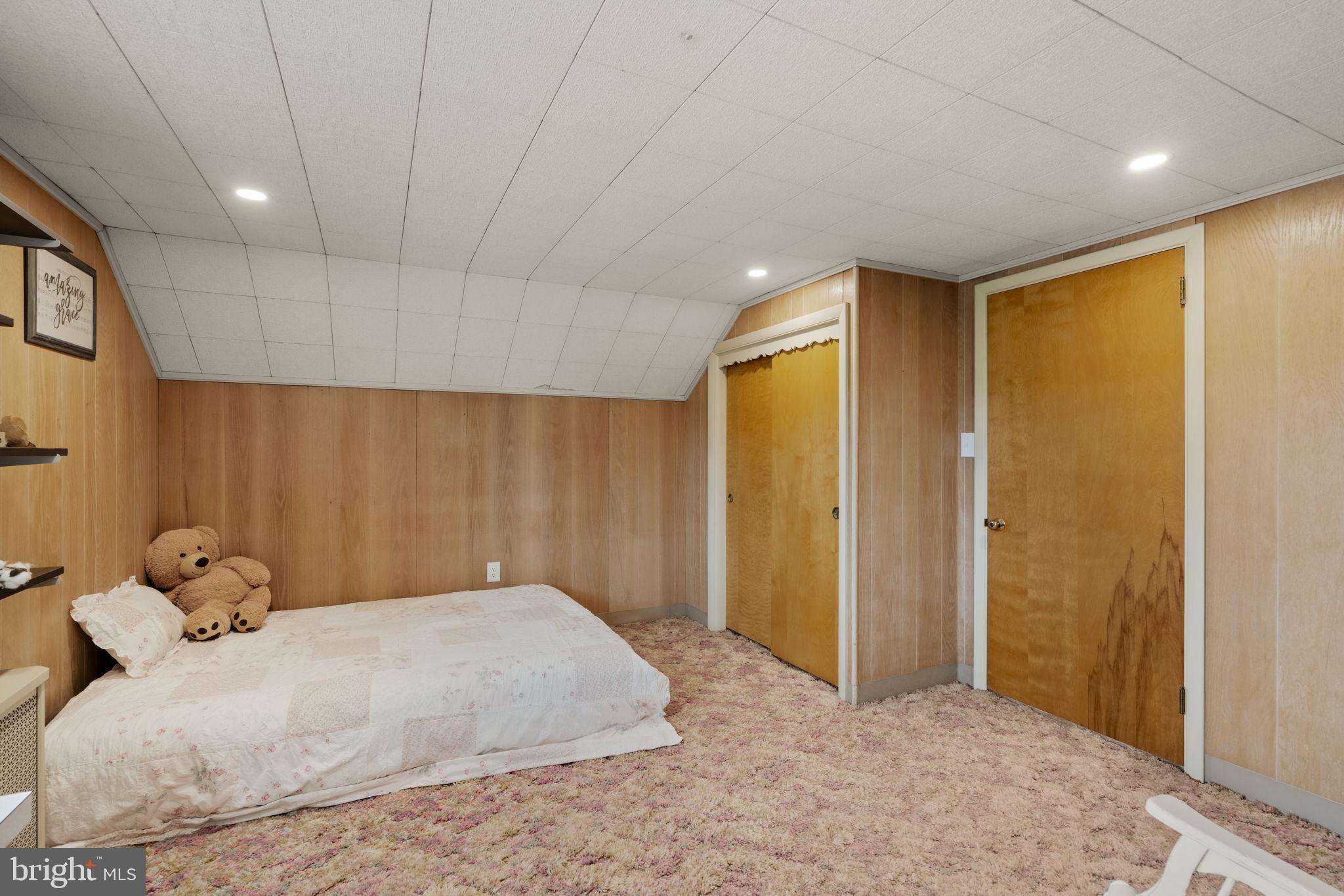 218 Lauschtown Road Denver, PA 17517 - Photo 47 of 78 a spacious bedroom with a large bed and a chandelier