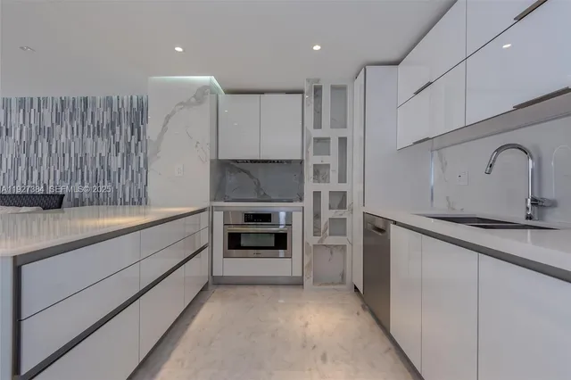 a kitchen with granite countertop a refrigerator stove and sink