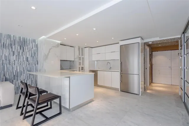 a kitchen with a refrigerator and a table