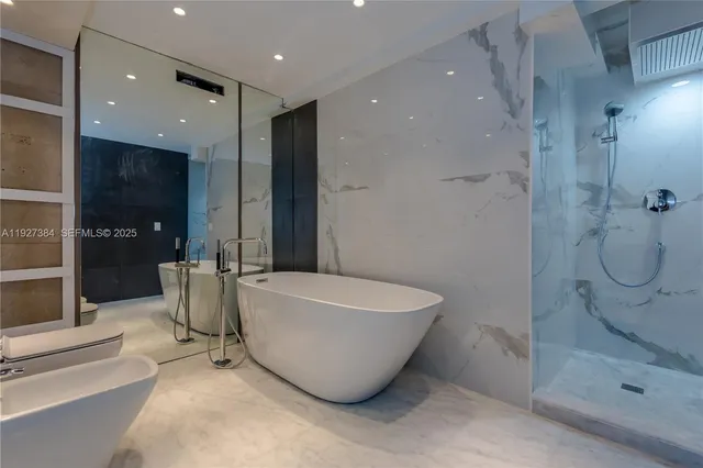a bathroom with a bathtub and shower