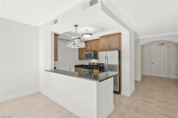 a kitchen with stainless steel appliances a refrigerator and a sink