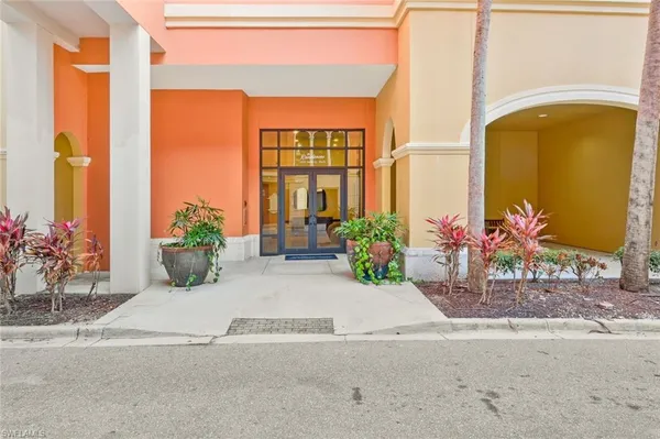 a potted plant sitting on the side of a brick building