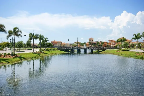 a view of a lake with houses in back