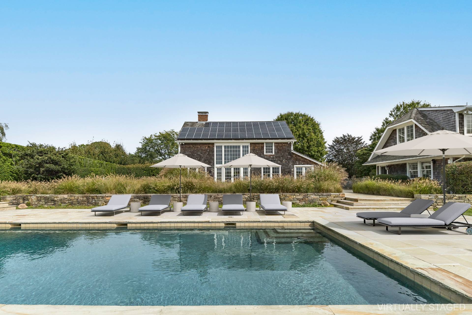 a swimming pool with outdoor seating and yard
