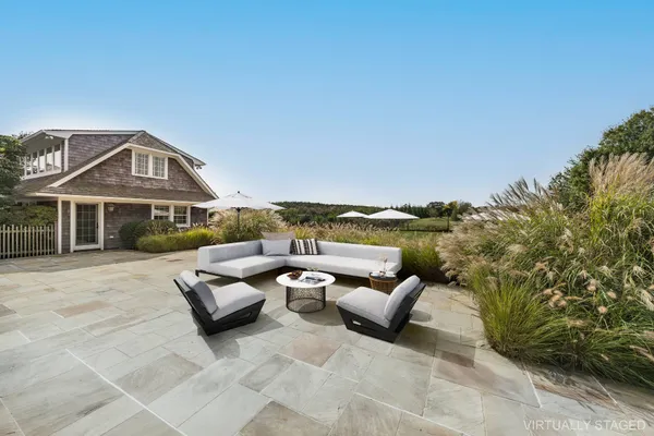 a view of a patio with couches and potted plants