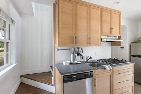 a kitchen with granite countertop a sink cabinets and window