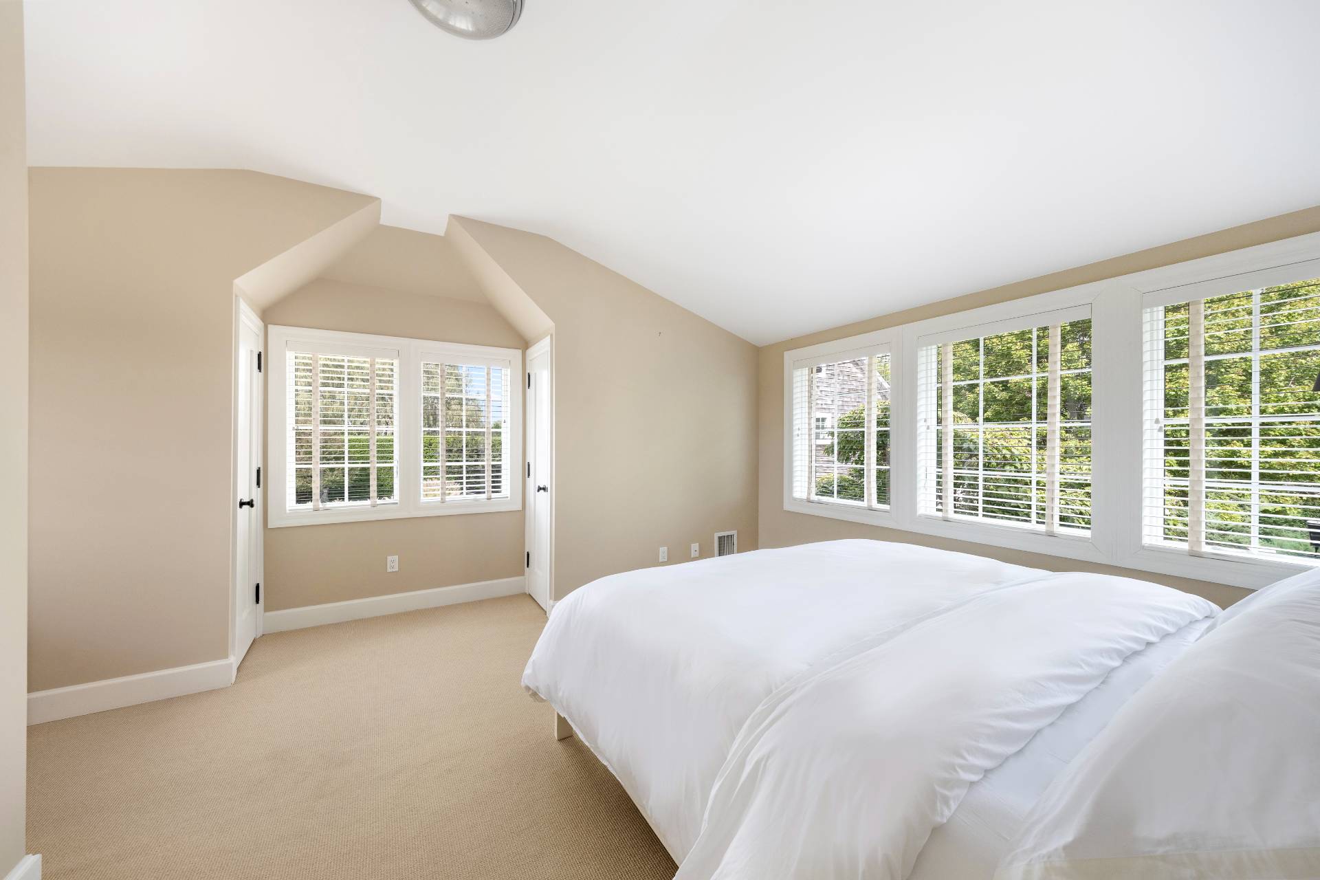 940 Deerfield Road Water Mill, NY 11976 - Photo 18 of 22 a large bed sitting in a bedroom next to a window