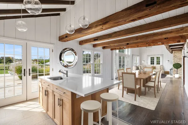 a large kitchen with a table and chairs