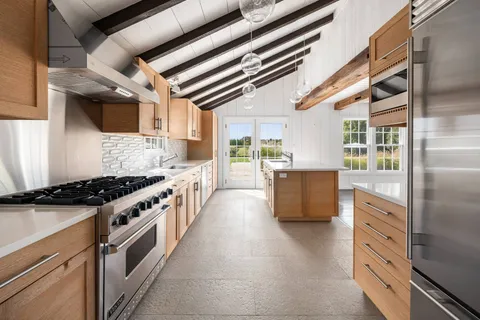 a kitchen with stainless steel appliances granite countertop a stove and a refrigerator