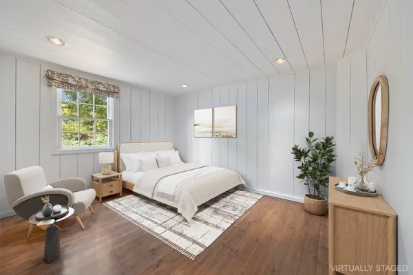 a living room with furniture potted plant and a window