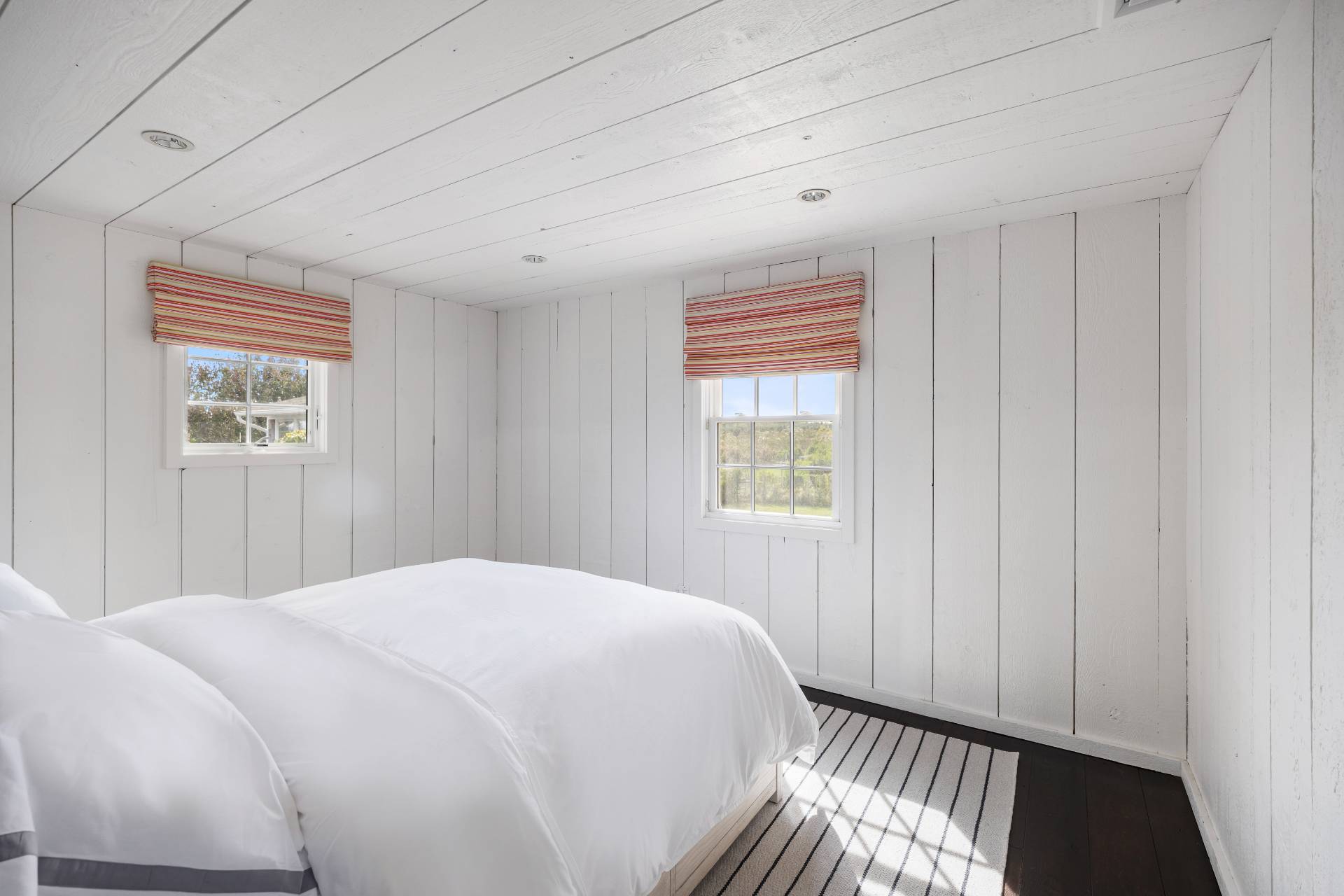 940 Deerfield Road Water Mill, NY 11976 - Photo 9 of 22 a bedroom with a bed and a window