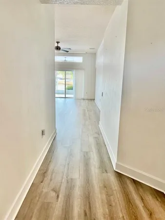 a view of a room with wooden floor and a window