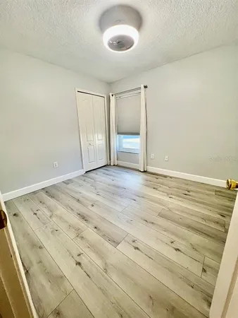 a view of a room with wooden floor