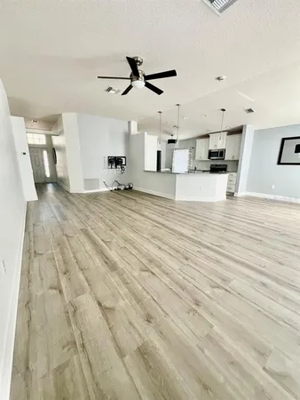a view of a living room and kitchen