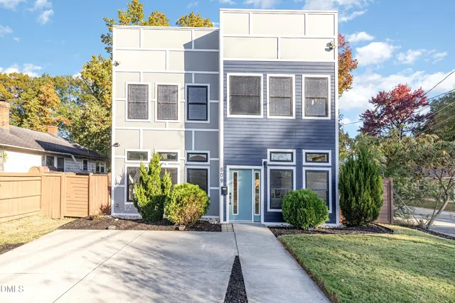 a view of a brick building next to a yard