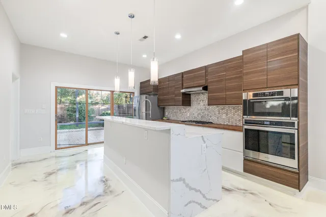 a dining room with furniture and a chandelier