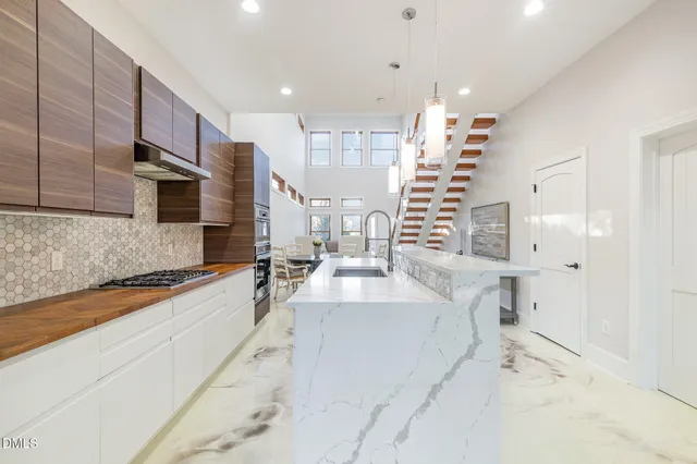 a kitchen with stainless steel appliances granite countertop a sink and cabinets