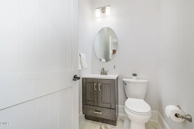 a large kitchen with kitchen island white cabinets and stainless steel appliances