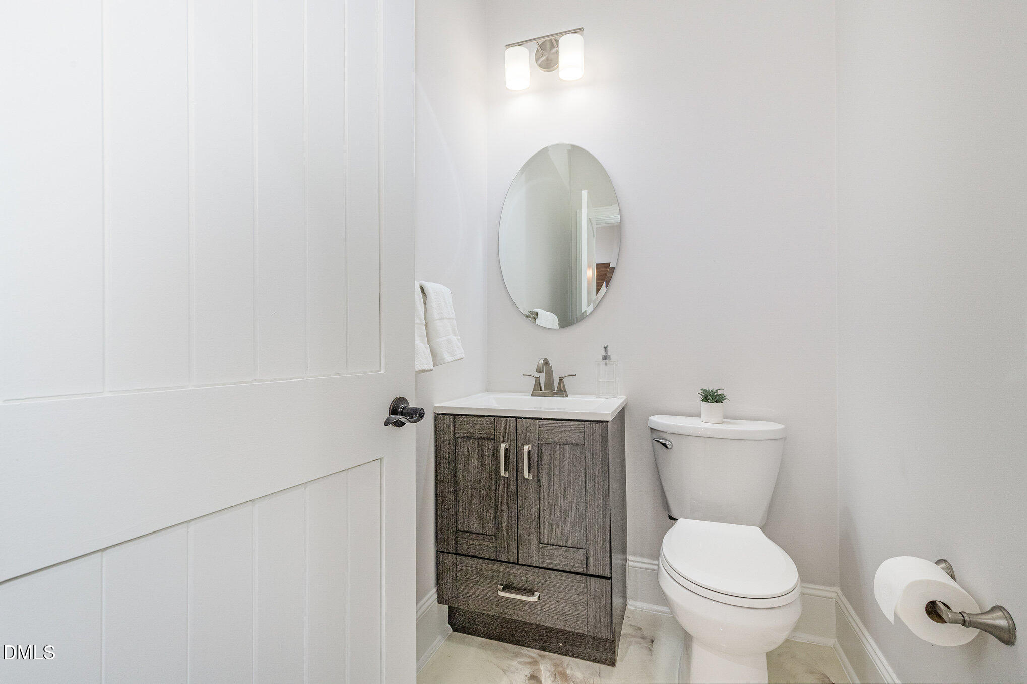 809 Drew Street Durham, NC 27701 - Photo 15 of 38 a bathroom with a toilet sink and mirror