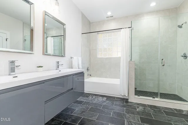 a bathroom with a bathtub and a shower