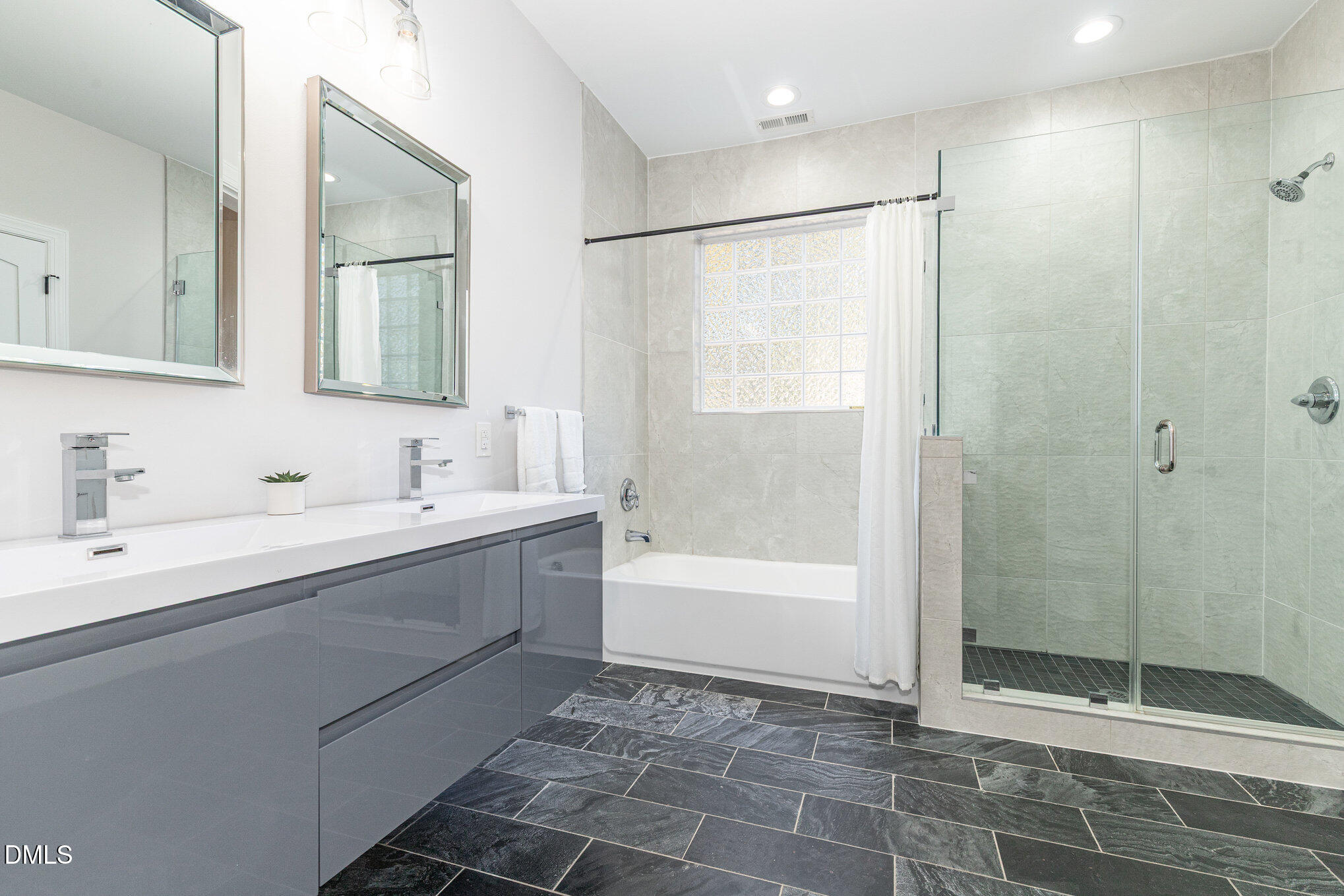 809 Drew Street Durham, NC 27701 - Photo 21 of 38 a bathroom with a shower sink and mirror