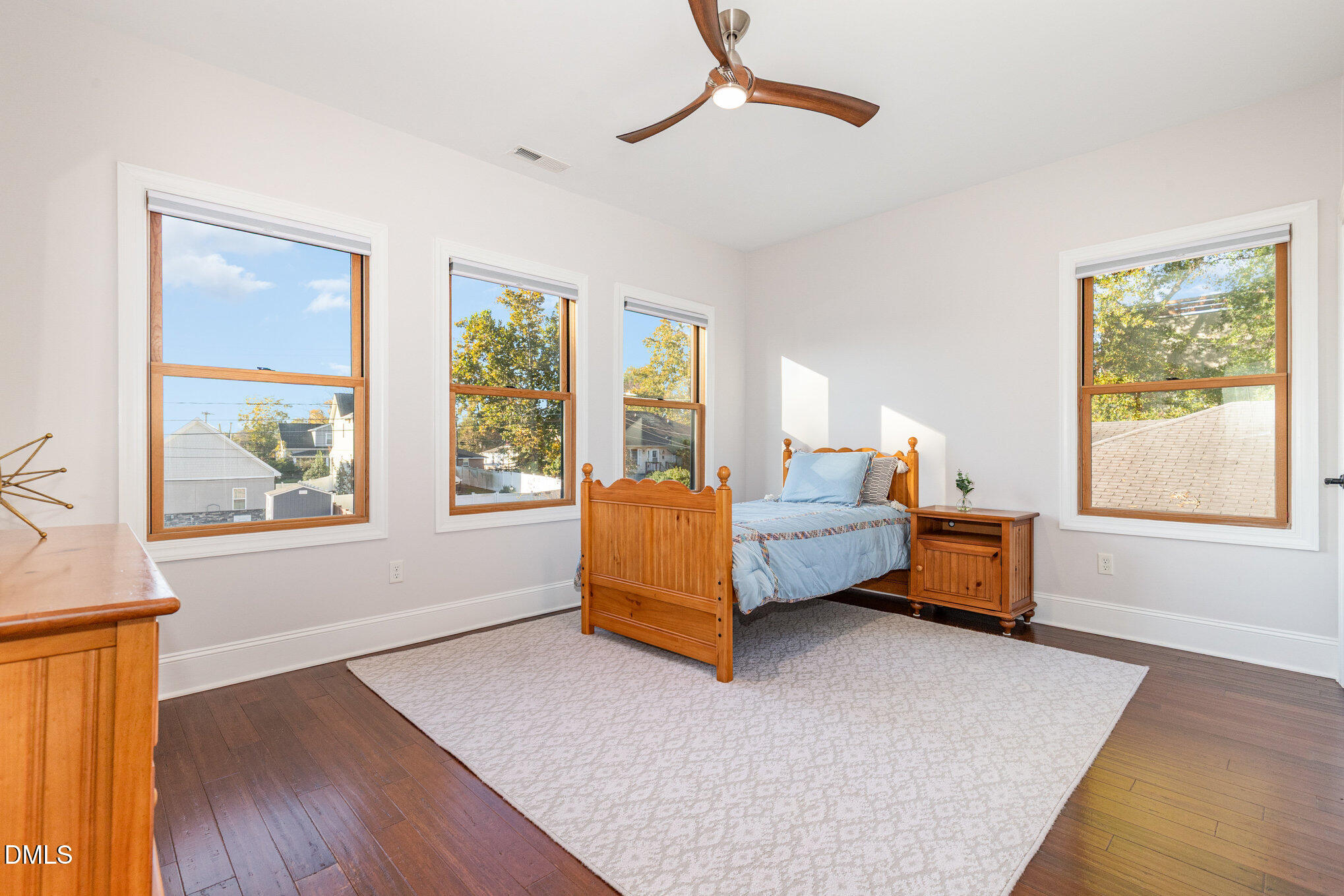 809 Drew Street Durham, NC 27701 - Photo 25 of 38 a bedroom with a bed and wooden floor