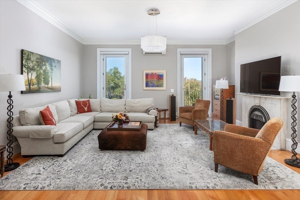 214 Beacon Street Boston, MA 02116 - Photo 5 of 21 a living room with furniture a flat screen tv and a fireplace