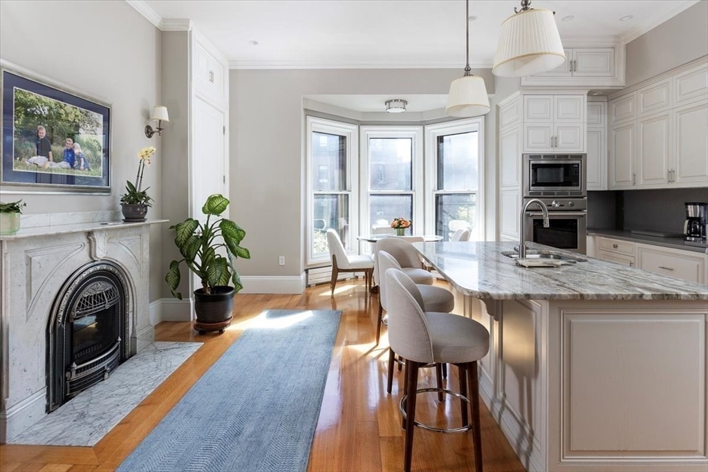 214 Beacon Street Boston, MA 02116 - Photo 8 of 21 a view of a kitchen with furniture and a fireplace