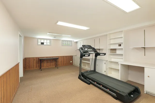a room with gym equipment and white walls