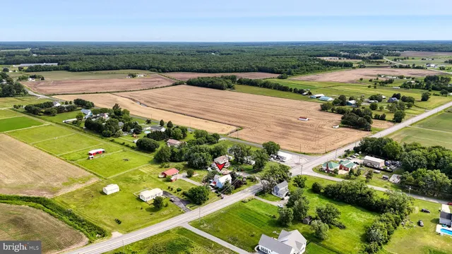 an aerial view of a house with a garden and lake view