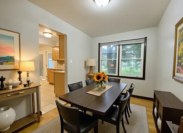a view of a dining room with furniture and window