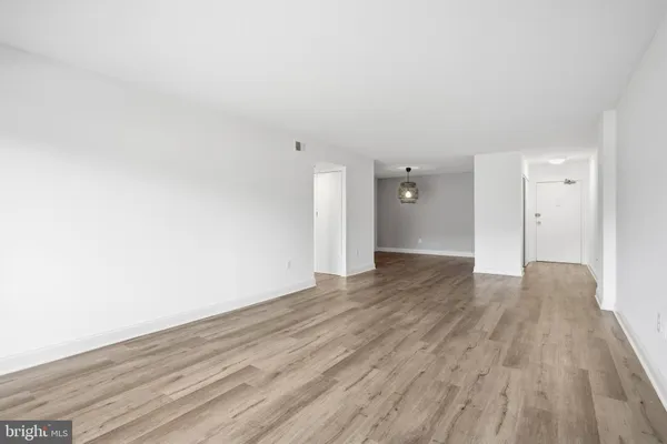 a view of an empty room and wooden floor