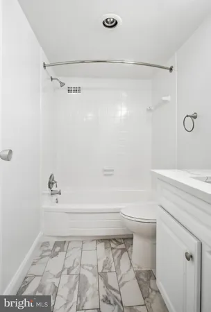 a bathroom with a shower and a toilet