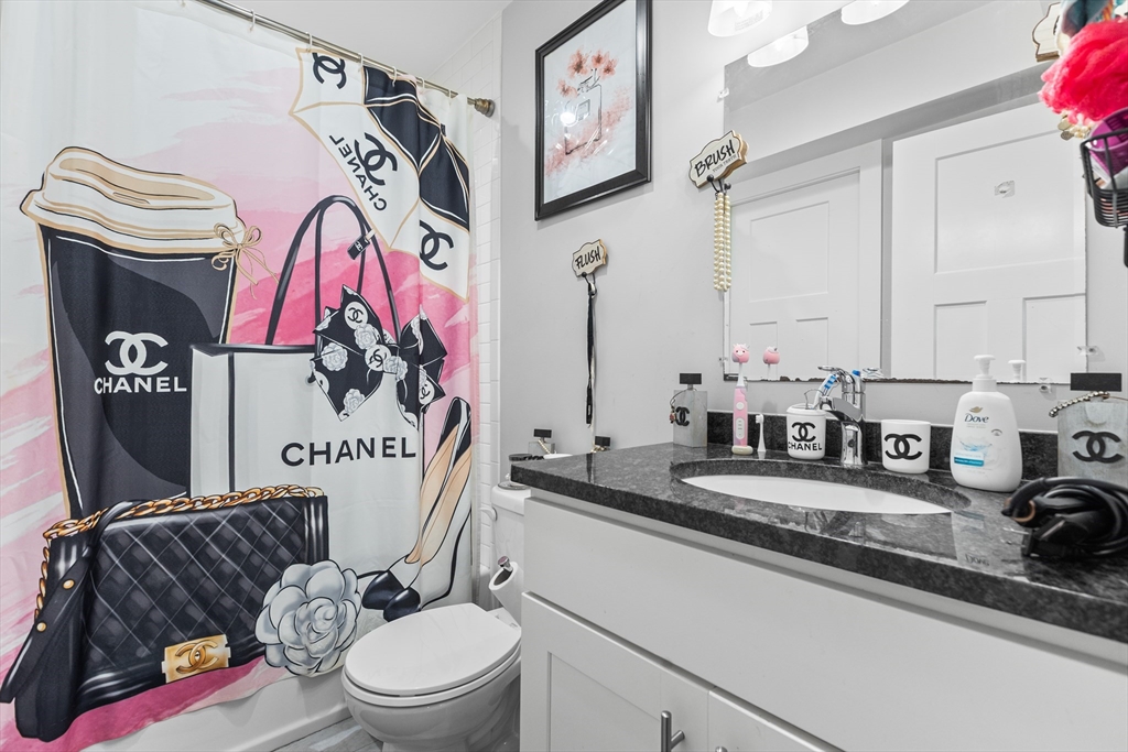 88 Gordon Avenue, Unit 2 Boston, MA 02136 - Photo 12 of 27 a bathroom with a granite countertop sink mirror vanity and toilet