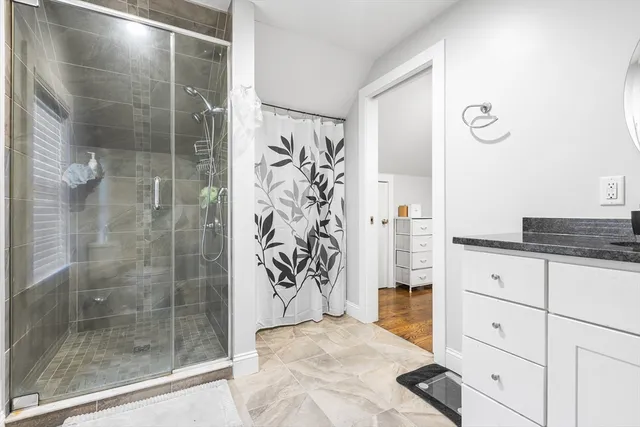 a bathroom with a shower and a sink
