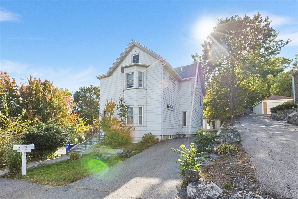 88 Gordon Avenue, Unit 2 Boston, MA 02136 - Photo 22 of 27 a front view of a house with a yard and garage