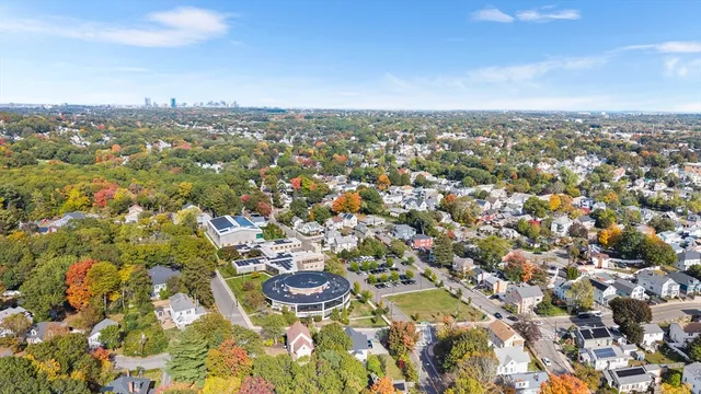 an aerial view of a house with a yard and garden