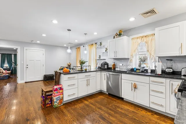 a kitchen with a white cabinets and stove top oven