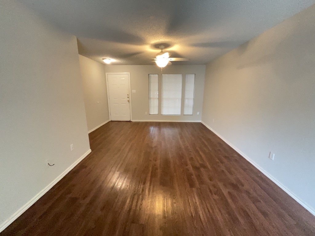 3413 Walleye Way Round Rock, TX 78665 - Photo 3 of 21 wooden floor in an empty room with a window