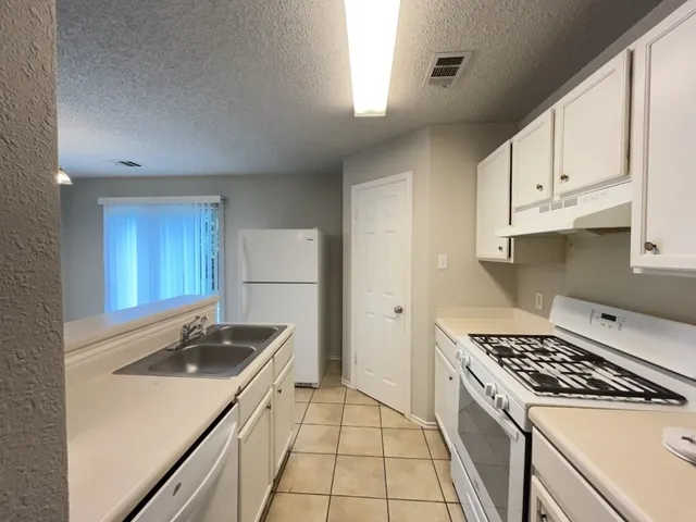 a kitchen that has a sink and a stove