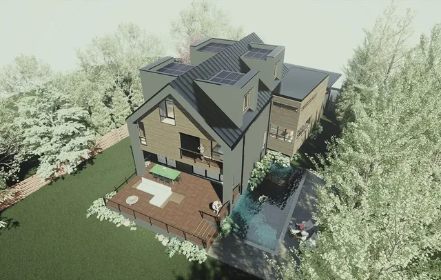 an aerial view of a house with a yard lake and trees all around