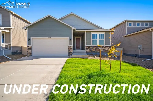 a view of an house with backyard space and a car
