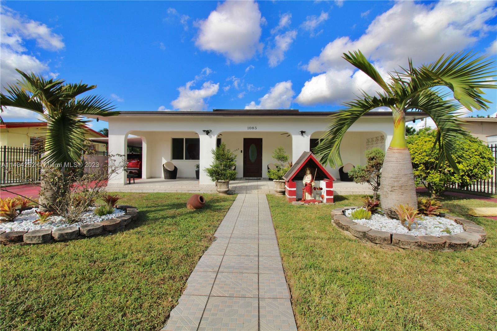 1085 West 23rd Street Hialeah, FL 33010 - Photo 1 of 32 a front view of a house with swimming pool and sitting area
