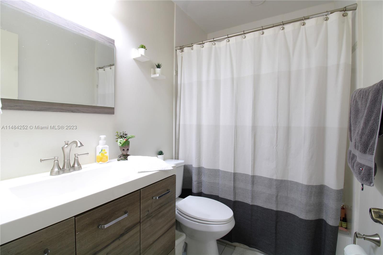 1085 West 23rd Street Hialeah, FL 33010 - Photo 12 of 32 a bathroom with a sink and a mirror