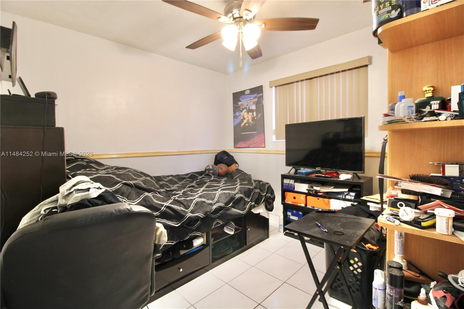 1085 West 23rd Street Hialeah, FL 33010 - Photo 13 of 32 a bedroom with a bed and a flat screen tv