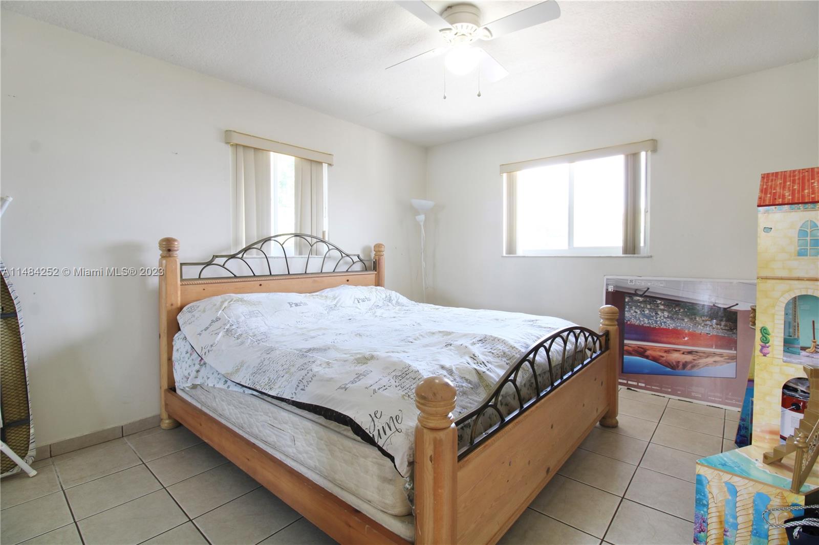 1085 West 23rd Street Hialeah, FL 33010 - Photo 18 of 32 a bedroom with a bed and a chandelier