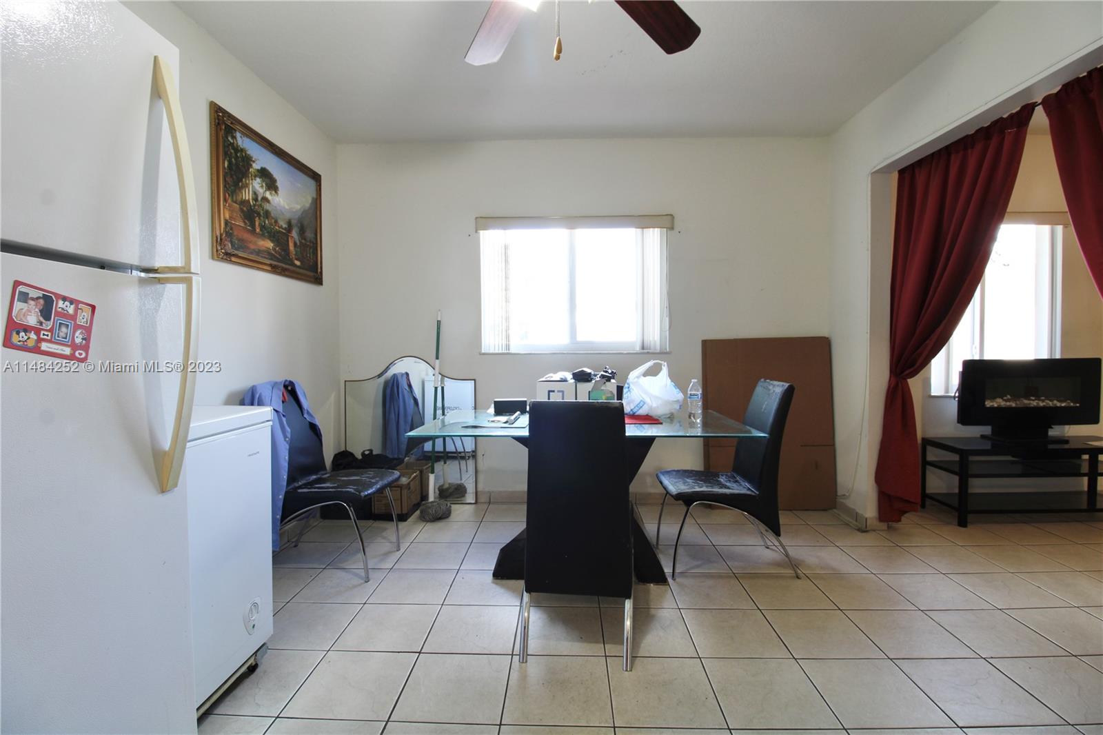 1085 West 23rd Street Hialeah, FL 33010 - Photo 20 of 32 a living room with furniture a window and a flat screen tv