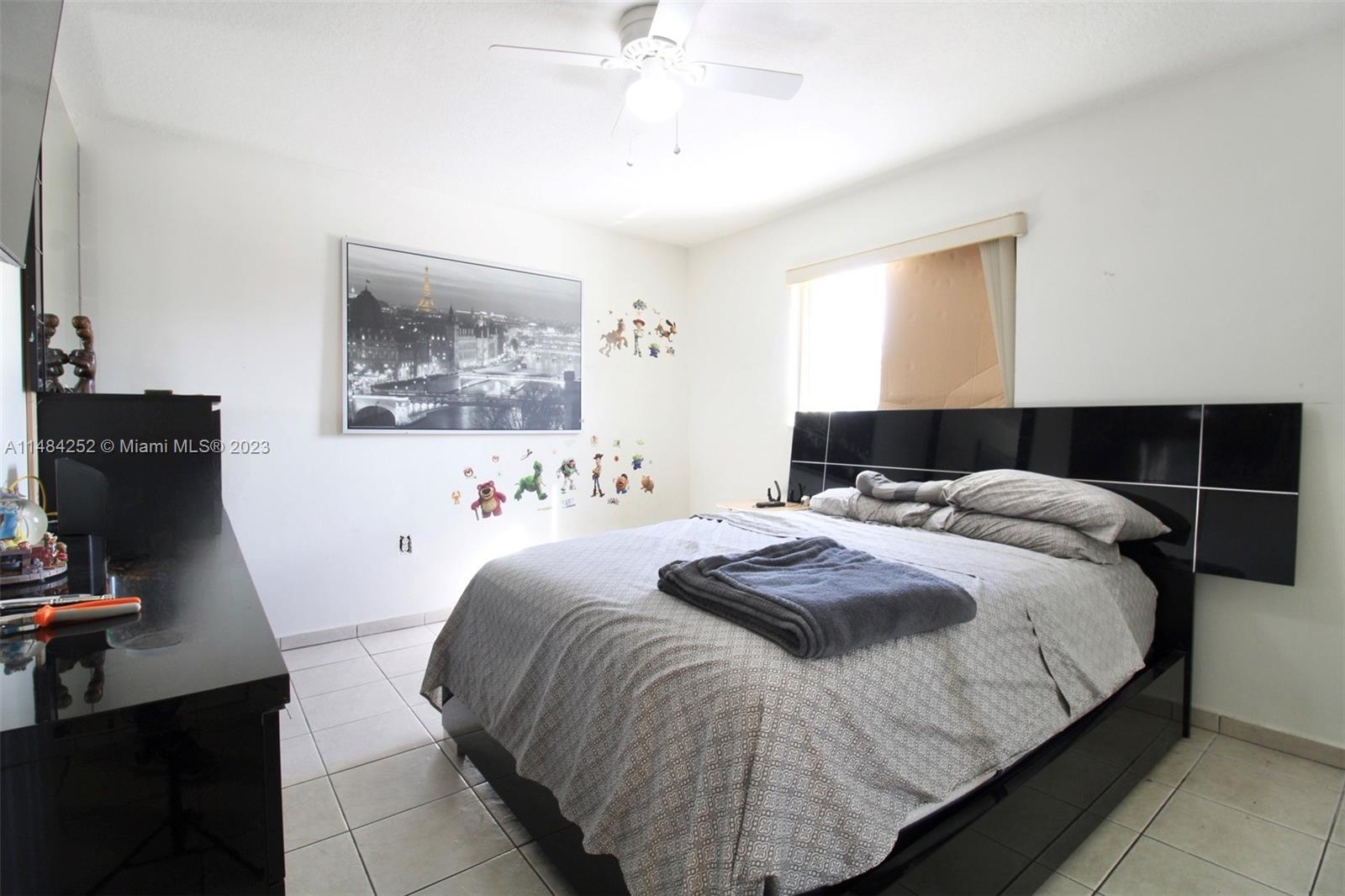 1085 West 23rd Street Hialeah, FL 33010 - Photo 23 of 32 a bedroom with a bed and a window