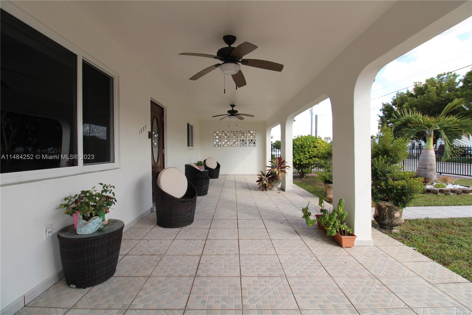 1085 West 23rd Street Hialeah, FL 33010 - Photo 3 of 32 a view of a entryway with flower pots